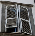 Low angle shot of an old window with white shutters in the town of Lucca in Tuscany Italy Royalty Free Stock Photo