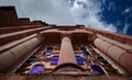 Low angle shot of Paola parish church facade with blue glass in Malta under cloudy sky Royalty Free Stock Photo