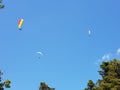 Low angle shot of parachutists flying in a blue sky Royalty Free Stock Photo