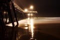 Low angle shot of the pier from the Pacific Coast during late at night Royalty Free Stock Photo