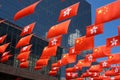 Low angle shot of the red flags of the PRC and HKSAR hung on a street in Hong Kong