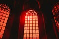 Low angle shot of the red light of sun shining through the arch shaped windows on an old building Royalty Free Stock Photo