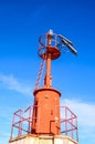 Low angle shot of a red steel lighthouse under a blue sky near Sottomarina, Venice Royalty Free Stock Photo