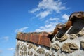 Low angle shot of the side of an old concrete building with a rusty rooftop under a beautiful sky