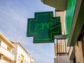 Low angle shot of the sign of pharmacy with a thermometer displaying 23 degrees Celsius