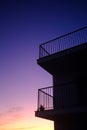 Low angle shot of a silhouette of building with a blue and purple sky in the background