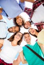 Low angle shot of six international students with toothy smiles, posing and bonding, on a sky background. Cheerful, smart and