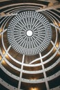 Low angle shot of a spiraling parking garage with a light dome on the top. Royalty Free Stock Photo