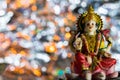 Low-angle shot of the statue of Lakshmi -the Goddess of wealth and prosperity on a Pink-lotus flower in Diwali Pooja