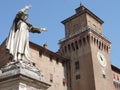 Low angle shot of a statue next to a historic ancient building in Ferrara, Italy