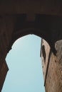 Low angle shot of a stone arch on an old building in vertical Royalty Free Stock Photo
