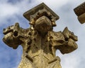 Low angle shot of a stone cross sculpture under the beautiful blue sky Royalty Free Stock Photo