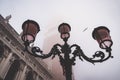 Low-angle shot of a street lantern in Venice at mist with a bird in the sky Royalty Free Stock Photo