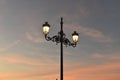 Low angle shot of street lights under the beautiful sunset sky Royalty Free Stock Photo