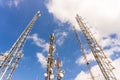 Low angle shot of tall cell towers against the sky