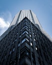 Low angle shot of a tall city building with a blue sky in the background  in New York Royalty Free Stock Photo