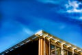 Low angle shot of a tall glass and metal building under a cloudy blue sky Royalty Free Stock Photo