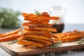 a low angle shot of tall stack of sweet potato fries