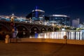 Low-angle shot of Tempe Town Lake and nearby buildings and bridges at night, AZ Royalty Free Stock Photo