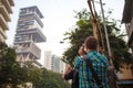 Low angle shot of a tourist taking photo of Antilia Ambani house in Mumbai