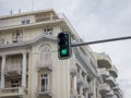 Low angle shot of a traffic light with a modern building with balconies in the background Royalty Free Stock Photo