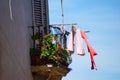 Low angle shot of tropical colored balcony with laundry hanging on a clothesline Royalty Free Stock Photo