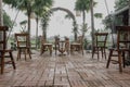 Low angle shot of a wedding outdoors design with tables, chairs and an arch with flowers Royalty Free Stock Photo