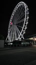 Low-angle shot of the Wheel of Brisbane during the night with white lights.