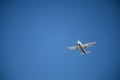 Low angle shot of white Finnair airplane in the blue sky