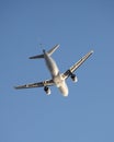 Low angle shot of white Finnair airplane in the blue sky