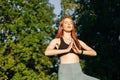 Low angle shot of woman with closed eyes practicing yoga and meditation performing namaste pose Royalty Free Stock Photo