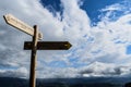 Low angle shot of a wooden sign showing Santa Barbara Dorrea Torre under the blue sky in Spain