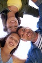 Family huddle. Low angle shot of a young family standing in a huddle outside. Royalty Free Stock Photo