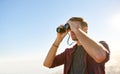 Low angle shot of a young man using binoculars Royalty Free Stock Photo