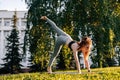 Low-angle shot of young woman practicing yoga in down facing dog pose on one leg Royalty Free Stock Photo