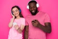 Close up of happy interracial couple wearing modern headphones in studio Royalty Free Stock Photo