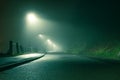 Low angle of a spooky country road, going into the distance with street lights, glowing on a moody foggy winters night