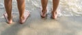 Low angle two child walking barefoot on beach. Feet of children walking barefoot on sand Royalty Free Stock Photo