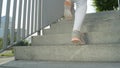 LOW ANGLE: Unrecognizable female jogger runs up a flight of concrete stairs. Royalty Free Stock Photo