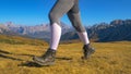 LOW ANGLE: Unrecognizable fit woman goes hiking in the picturesque Dolomites.