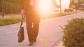 LOW ANGLE: Unrecognizable sad man in a suit walking down the street at sunset. Royalty Free Stock Photo