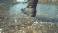 LOW ANGLE: Unrecognizable woman in furry boots running in the tranquil stream.