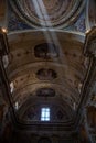 Low-angle vertical shot of the ceiling of Church in Milan with sunlight