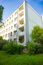 Low angle vertical shot of a modern architectural building with a blue sky in the background Royalty Free Stock Photo