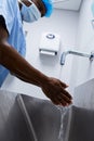 Male surgeon washing hands in sink at hospital Royalty Free Stock Photo