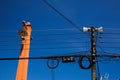 Low angle view against blue sky on isolated high voltage power poles with electric wires, distribution transformer and Royalty Free Stock Photo