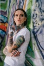 low angle view of attractive young tattooed woman