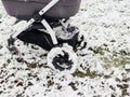 Low angle view of baby stroller carriage with bassinet in the snow field with Royalty Free Stock Photo