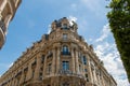 Low angle view of a beautiful old French building under blue sky