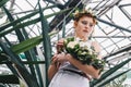 low angle view of beautiful tender young redhead bride holding wedding bouquet in botanical Royalty Free Stock Photo